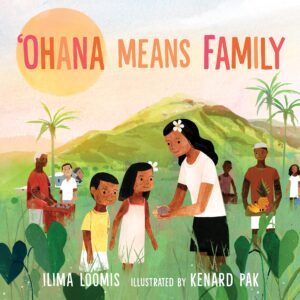 Cover of the book 'Ohana Means Family. There are eight people preparing for a luau, gathering food and working together. This is set in front of a green hill with a setting sun. The title is written in pink and orange lettering at the top.