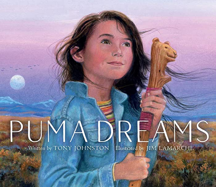Cover of "Puma Dreams." Features a girl holding her grandmother's staff in front of a sunset.