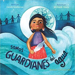 Front cover of the book Somos Guardianes del agua. Features an individual painted standing in a blue wave with long hair blowing behind them in the foreground, a crescent moon behind them, and shadows of people holding hands in the background.